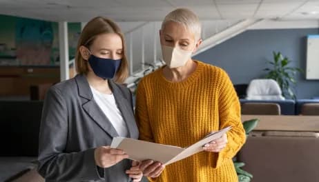 Two colleagues reviewing a document in an office